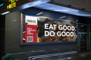 A fundraising billboard for "Food/Co." reading "Eat Good. Do Good."