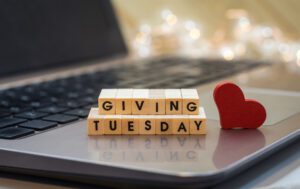 "Giving Tuesday" spelled in wooden blocks on a laptop.