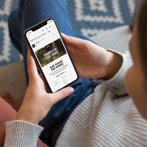 mockup-of-a-girl-sitting-on-a-couch-using-her-iphone-xs-25355